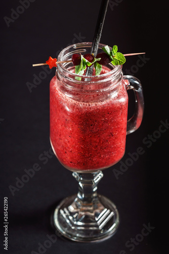 berry smoothie on black background photo