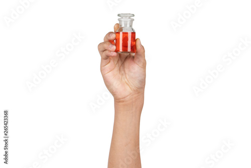 Reagent bottle or amber reagent glass wide mouth bottle with red water or red liquid holding by boy hand isolated on white background. Hand showing science glassware in laboratory.
