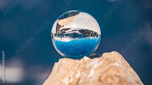 Crystal ball alpine winter landscape shot at the Buchensteinwand-Tyrol-Austria photo