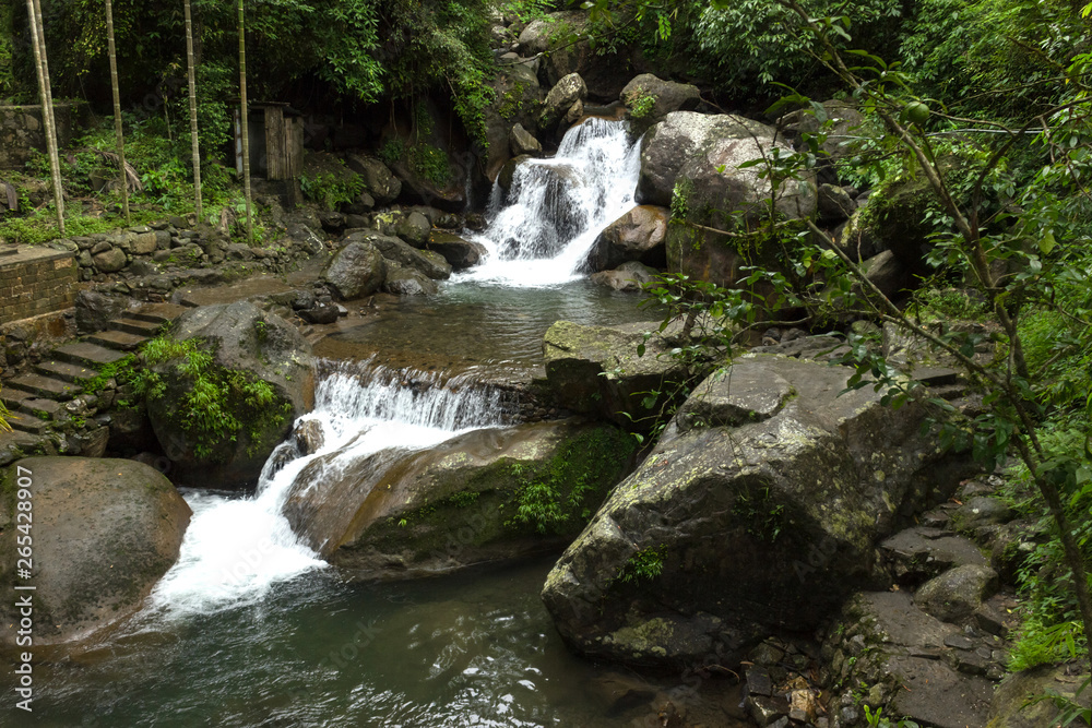 small waterfall nearby Double Decker Living Root Bridge in the Indian jungle small waterfall nearby Double Decker Living Root Bridge in the Indian jungle