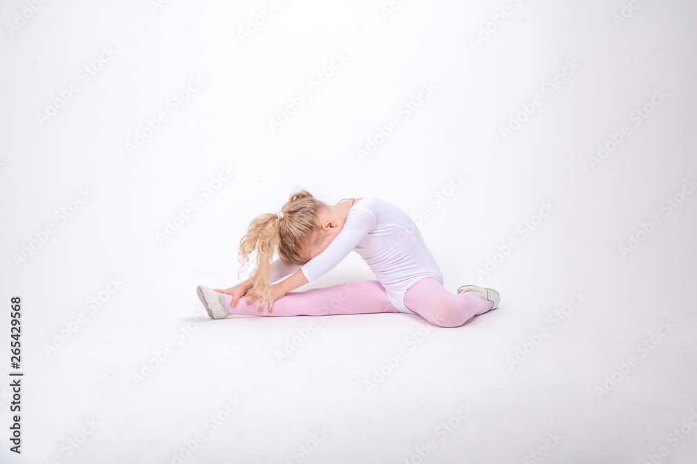 Smiling Little girl gymnast on a white background Smiling Little girl gymnast on a white background