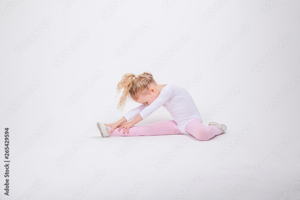 Smiling Little girl gymnast on a white background Smiling Little girl gymnast on a white background