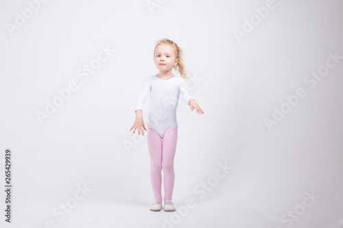 Happy little girl dancing isolated on white background