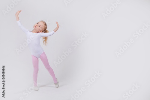 Happy little girl dancing isolated on white background