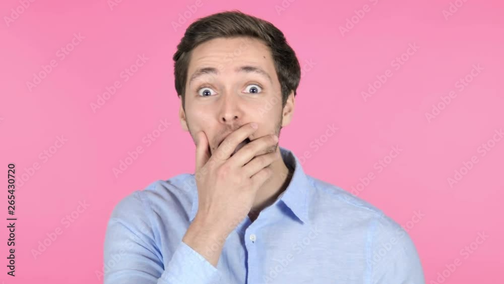 Surprised Young Man Wondering on Pink Background Surprised Young Man Wondering on Pink Background