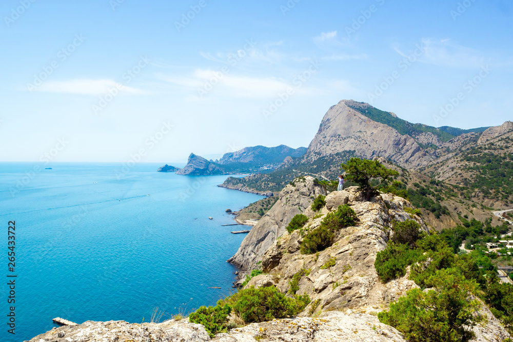 The view from the heights of the mountains, the sea and the blue sky with white clouds