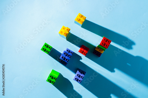 Columns from the children's designer on a blue background. The concept of building houses, new building. Flat lay, top view.