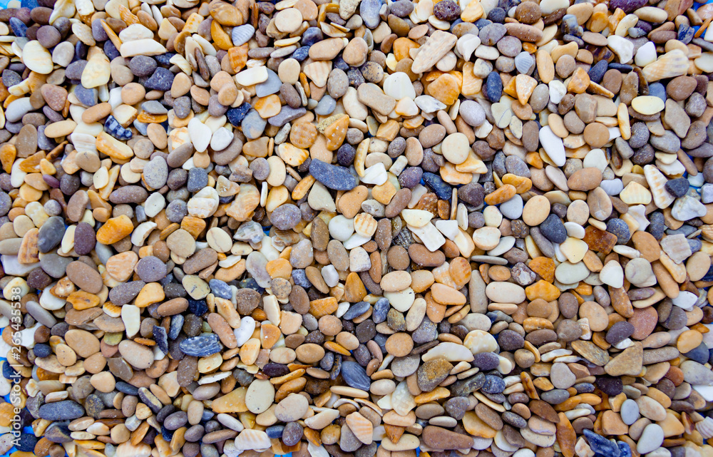 Multicolored round pebbles on the beach. Beautiful background Multicolored round pebbles on the beach. Beautiful background