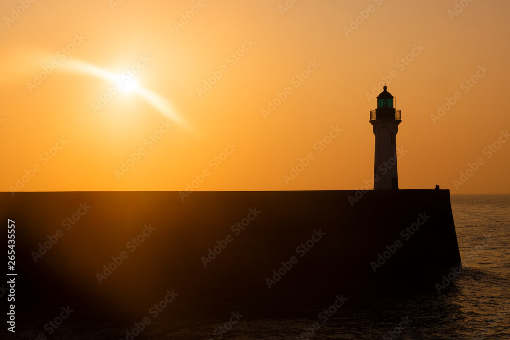 Cliff and Lighthouse at the entrance to the port of Saint Valery en Caux, sunset