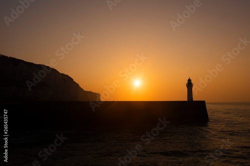 Cliff and Lighthouse at the entrance to the port of Saint Valery en Caux, sunset