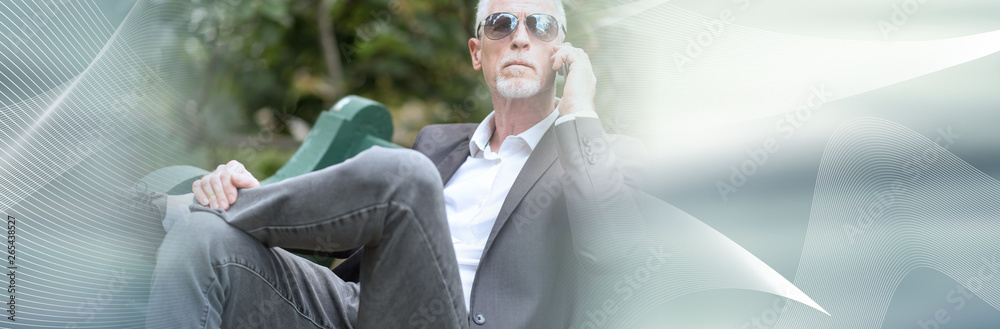 Obraz premium Mature man talking on mobile phone. panoramic banner