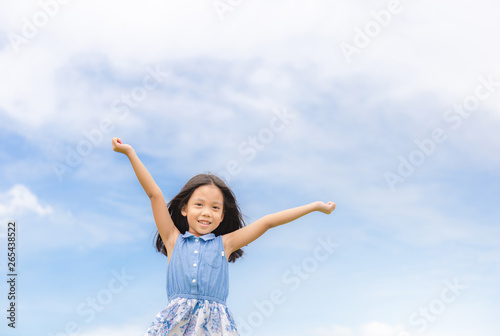 Happy beautiful child little girl white could and blue sky background with copy space