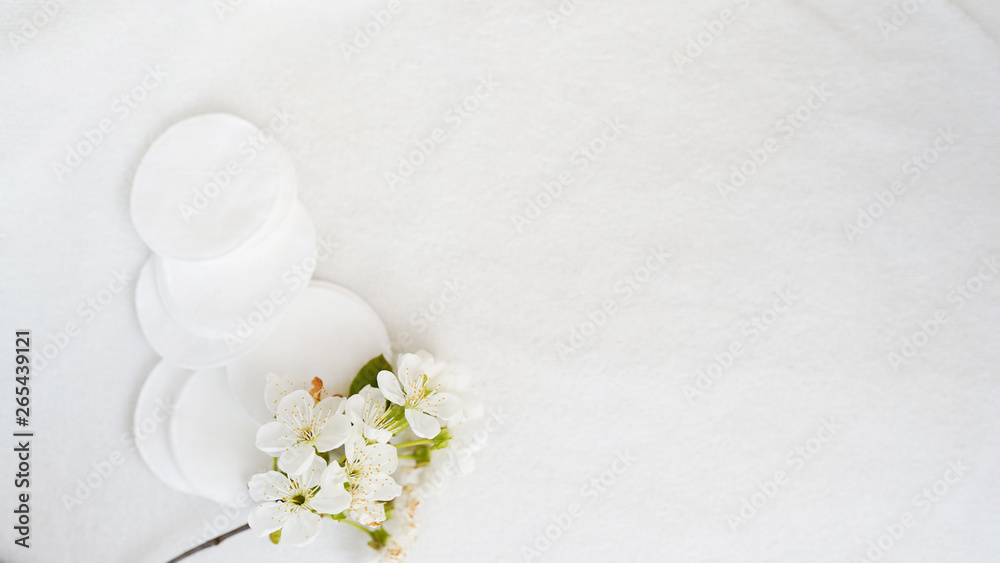Cotton pads and flower on white background with copy space . skin body care concept Cotton pads and flower on white background with copy space . skin body care concept