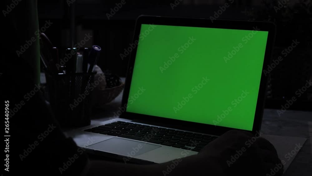 Laptop with green screen. Dark office. Perfect to put your own image or video.Green screen of technology being used. Chroma Key laptop Laptop with green screen. Dark office. Perfect to put your own image or video.Green screen of technology being used. Chroma Key laptop
