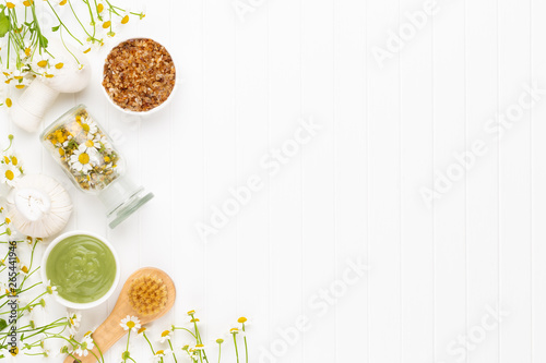 Spa still life with aromatherapy chamomile, herbal oil, soap, sea salt.