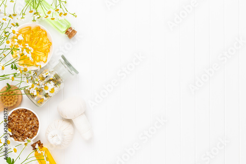 Spa still life with aromatherapy chamomile, herbal oil, soap, sea salt.