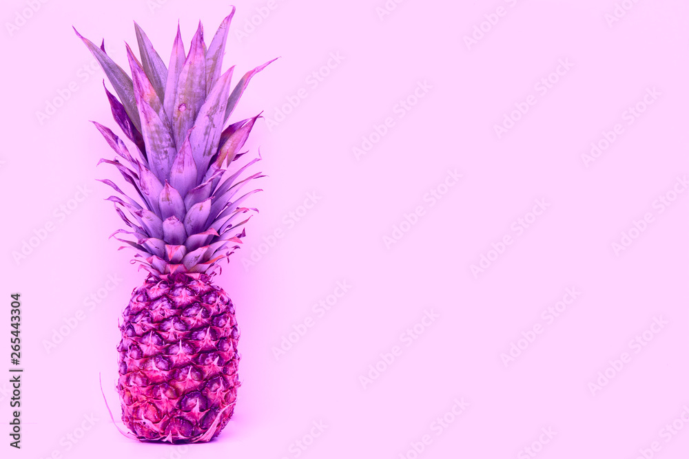 Fototapeta pineapple with green leaves on a pink background. Concept - vacation in the tropics