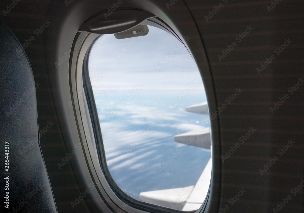 Window side of passenger with wing airplane flying