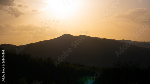 Beautiful landscape in the mountains at sunset. View of colorful sky with amazing clouds.