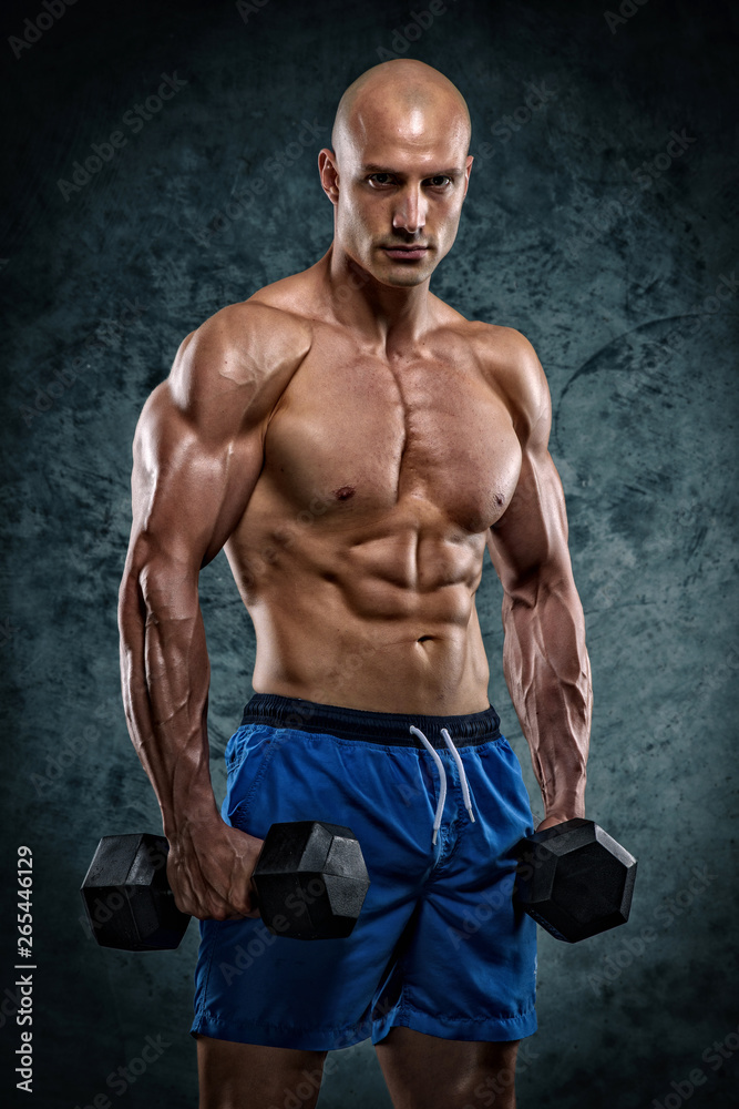 Fototapeta premium Handsome Muscular Men Lifting Weights, kettlebell