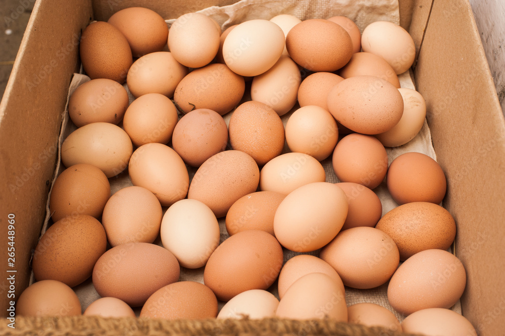 Many brown eggs in box. Chicken farm. Place for text. Preparation for Easter. Many brown eggs in box. Chicken farm. Place for text. Preparation for Easter.