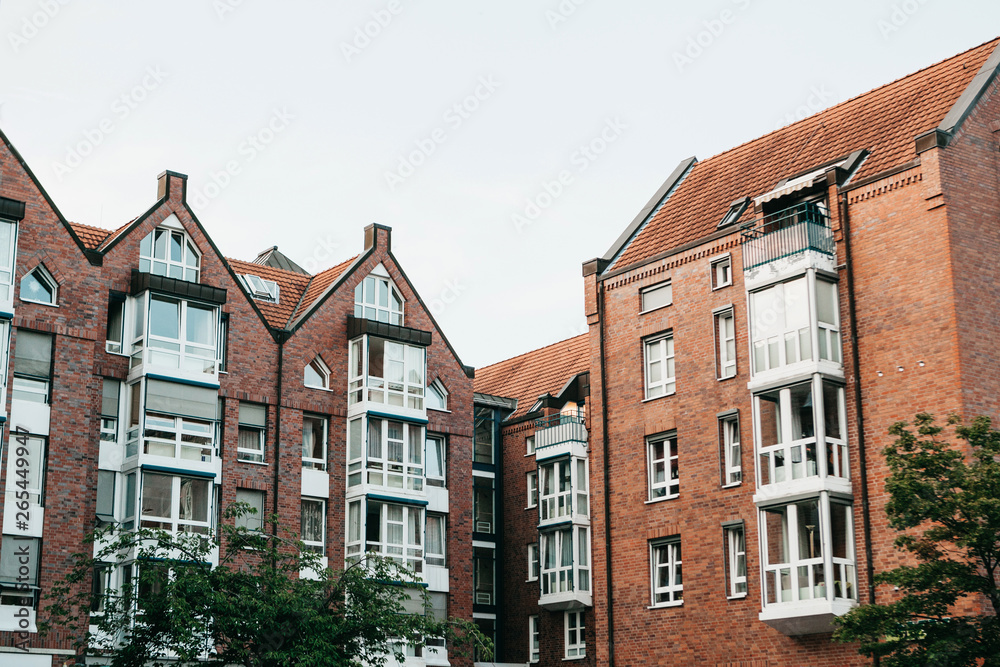 Residential buildings in Muenster in Germany. Ordinary houses in urban area. Apartment buildings in a row.