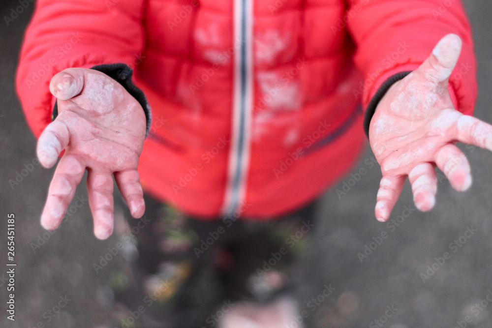 small children's dirty hands arms outstretched to the top on the asphalt background