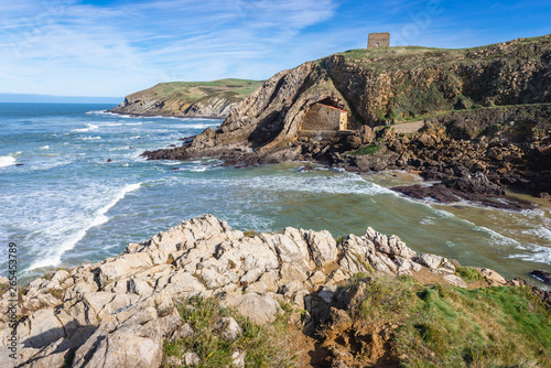 Aerial view on beach of Santa Justa on the Atlantic shore in Ubiarco village in northern Spain, view with hermitage and San Telmo medieval watchtower photo