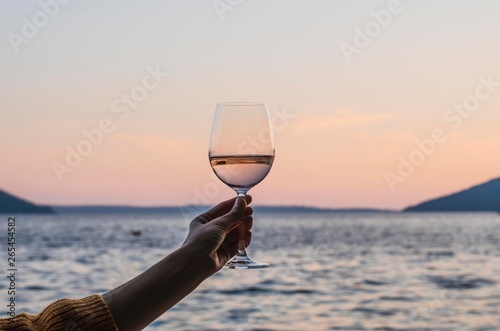 A glass of wine in her hand