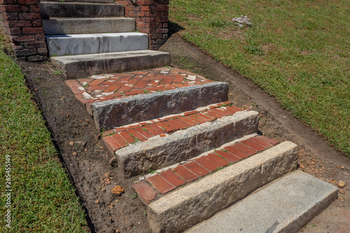 Old exterior steps and landings of rusticated stone, brick, and marble, horizontal aspect