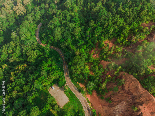 Top View of Rural Road, Path through the green forest and countryside of Thailand, Top view aerial photo from drone © aedkafl