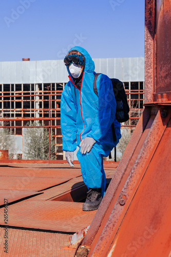 man environmental mask face pack disguise facemask bitmask protective overall blue sky orange rast plant factory disused catastrophe photo