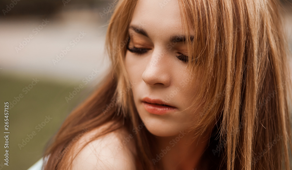 Portrait of a thoughtful girl with long hair. Copy space