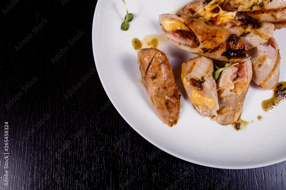 Spicy chicken fillet baked with bacon, tomatoes and cheddar cheese Spicy chicken fillet baked with bacon, tomatoes and cheddar cheese