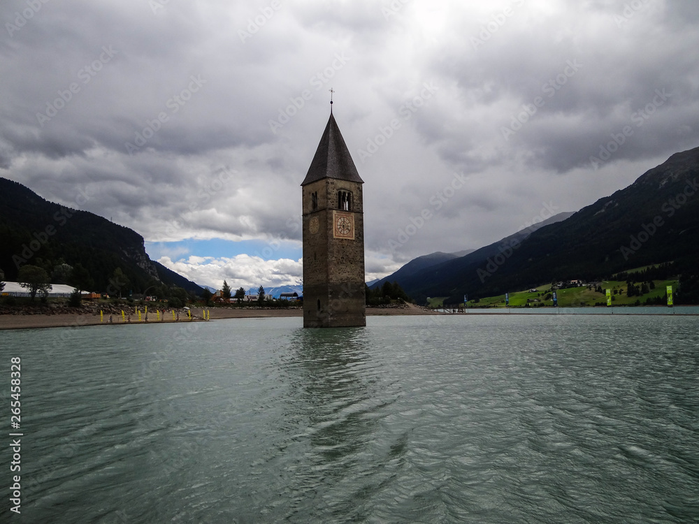 Graun im Vinschgau, flooded tower of church in the middle of lake. Italy