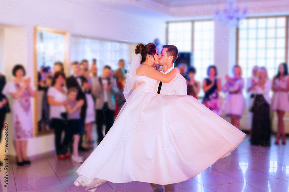 newlyweds whirling and kisses. wedding dance. guests in the rest newlyweds whirling and kisses. wedding dance. guests in the rest