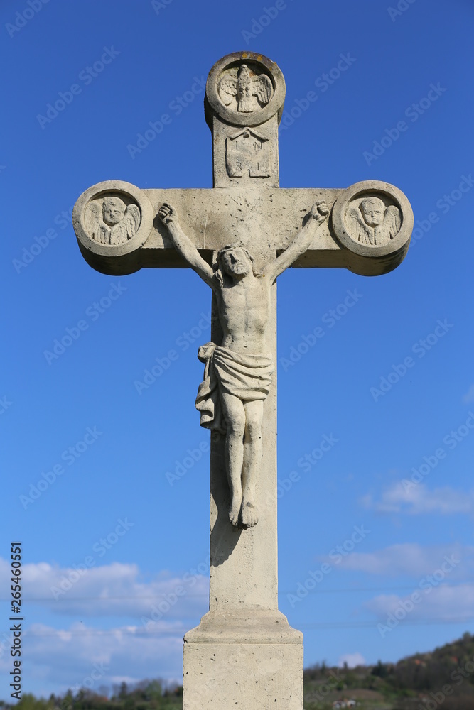  White stone cross against natural bue sky