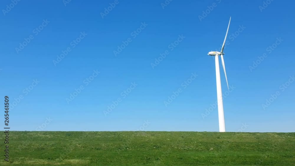 Thanksgiving against the blue sky. Windmill park in the lake IJsselmeer in Flevoland Netherlands. View from the car window at speed. Thanksgiving against the blue sky. Windmill park in the lake IJsselmeer in Flevoland Netherlands. View from the car window at speed.