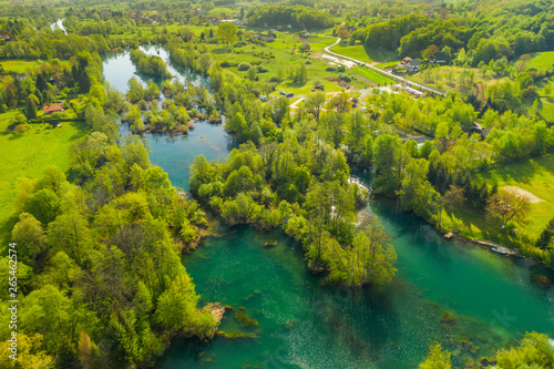 Beautiful river landscape, Mreznica in village of Belavici, Croatia, from drone, peaceful water surface, popular tourist destination