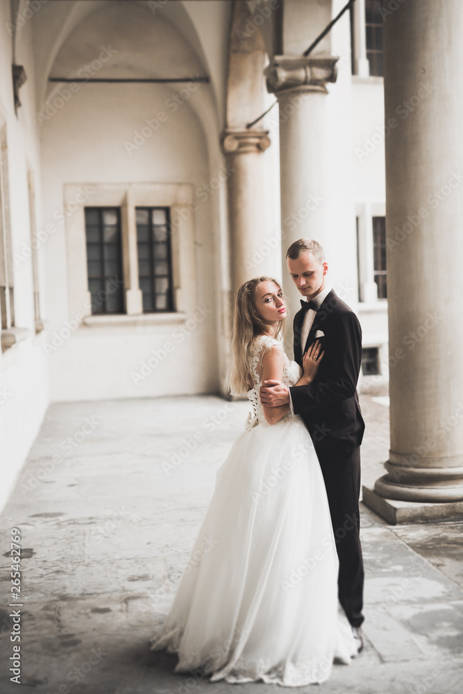 Gorgeous wedding couple walking in the old city