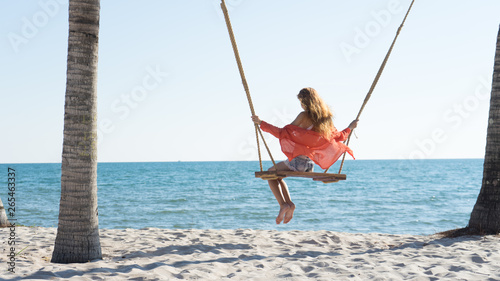 Vacation concept. Young woman swing on a beach swing. Happy traveller women on the Phu Quoc beach © Hryhorii