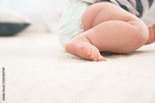 Cute little baby on carpet indoors, closeup with space for text. Crawling time