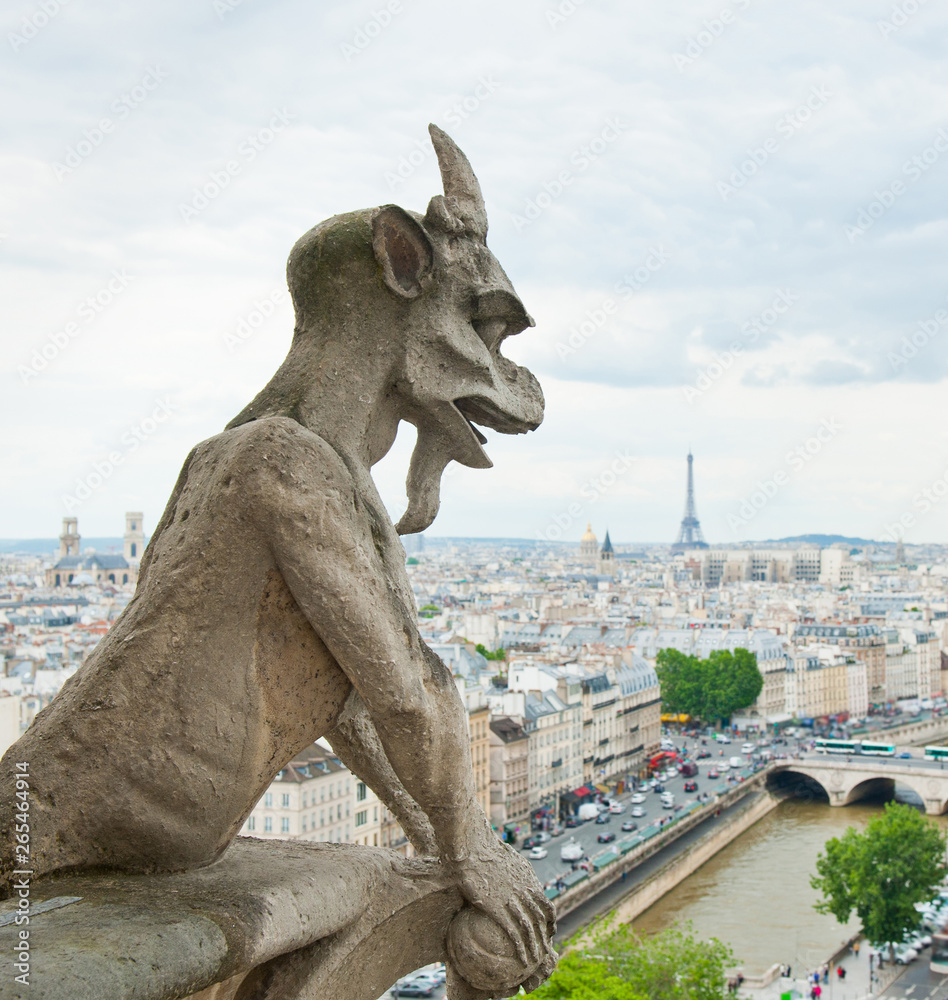 Chimera of Notre-Dame Cathedral. View of Paris and Eiffel Tower. France
