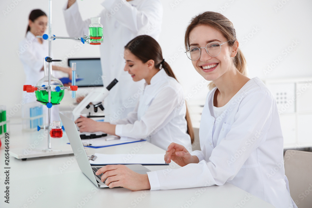 Medical students working in modern scientific laboratory Medical students working in modern scientific laboratory