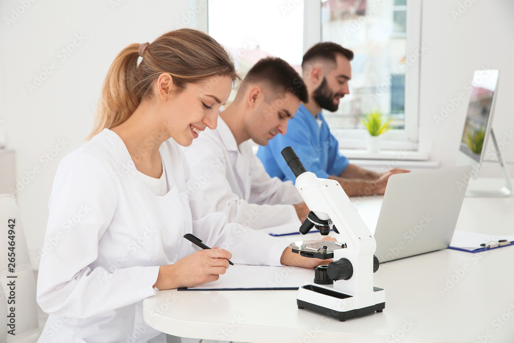 Medical students working in modern scientific laboratory Medical students working in modern scientific laboratory