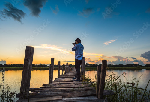 photographer on wooden bridge