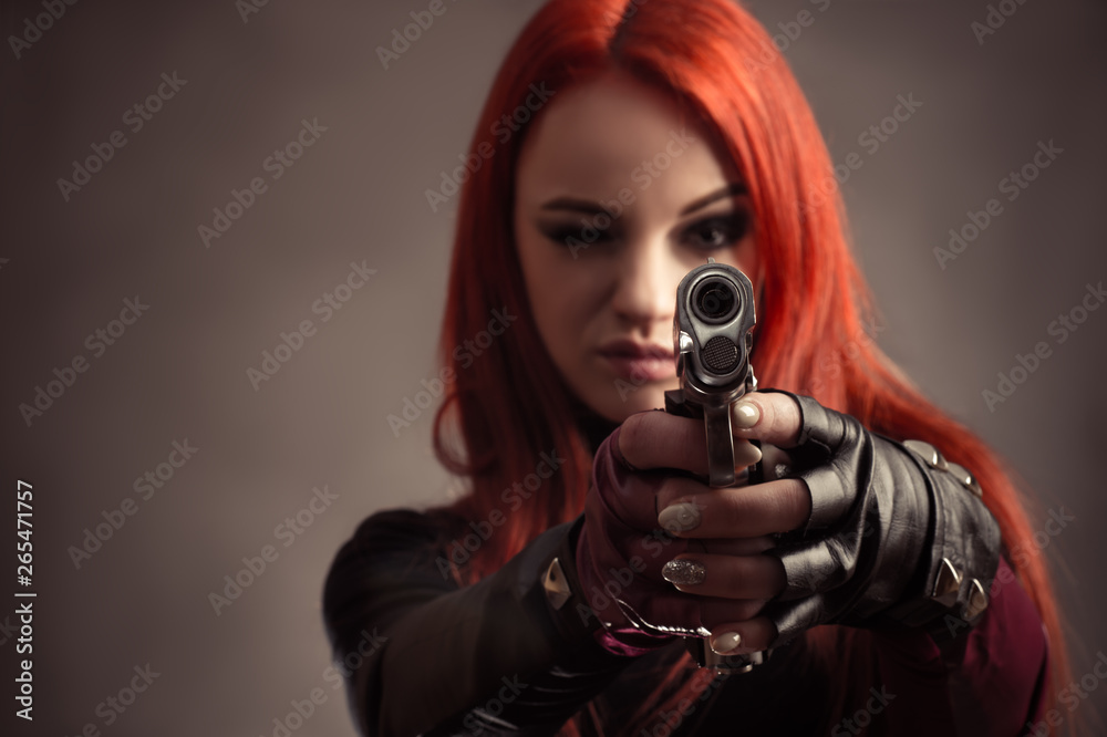 beautiful woman aim with pistol isolated on gray background beautiful woman aim with pistol isolated on gray background