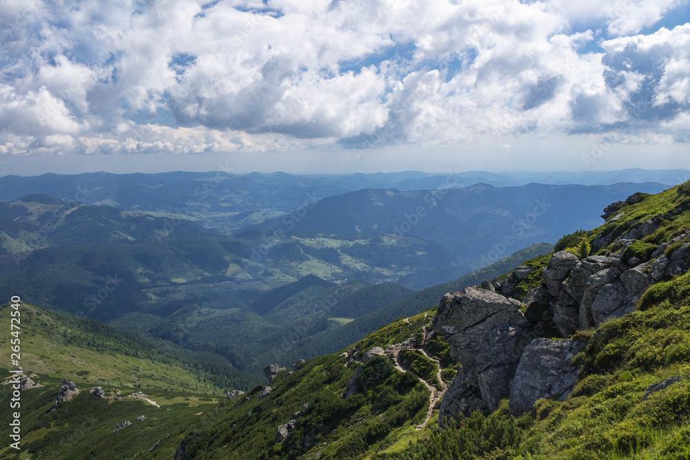 Fototapeta premium Scenic summer or spring mountain view with cloudy sky. Ukraine, Carpathians, Dzembronia High mountains in vivid color. Nobody. Beautiful mountain lanscape or valley.