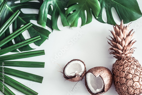 summer composition with tropical leaves and fruits on white background