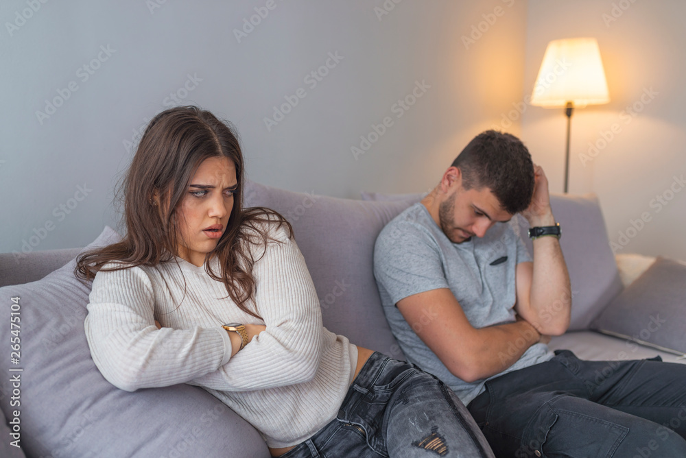 People, relationship difficulties, conflict and family concept - Unhappy couple having argument at home. Couple Having Argument At Home. Troubled woman expressing despair People, relationship difficulties, conflict and family concept - Unhappy couple having argument at home. Couple Having Argument At Home. Troubled woman expressing despair